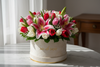 lillies and tulips in a round box, write rio de roses on the box