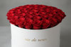 Red roses in in round white box and write rio de roses on the box 